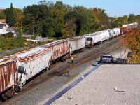 Ever have one of those days? Just before the long weekend, of course, CP 254's train had a little oops moment in the yard at CP Quebec Street. The inbound crew had just made their setoff and the outbound crew was making the lift when an empty hopper picked the yard lead/#2 track crossover, taking a couple other cars with it. Not only did it cause a bit of confusion for CP, but also for vehicle traffic on Adelaide street while the yard job (TL-11) made several moves to swing the rear of the train onto the passing track (across the grade crossing) so that 254 could continue eastward. And to add insult to injury, the lead engine was having computer problems...