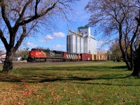 A pair of EMDs lead a manifest through Oakville.