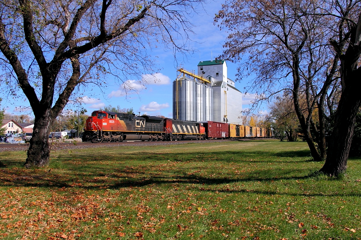 A pair of EMDs lead a manifest through Oakville.