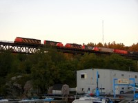 CN 2405 North cruising across the trestle that spans "the sound" during the last few seconds of any usable light, with a consist of CN 2405/CN 5250/CN 4710/CN 4761 and 100 cars of X301's freight in tow from Mac yard to Symington.