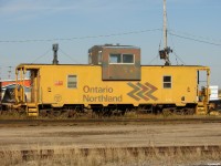 ONT 126 in excellent shape, esthetically, sits on the RIP track with an old green 40' boxcar soaking up some fall sunshine in Hearst.