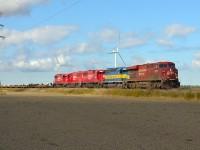 CP 240 led by a GE, DME and a trio of rebuilt ex SOO's passes eastbound thru Haycroft. The headend had a long string of empty windmill flats.