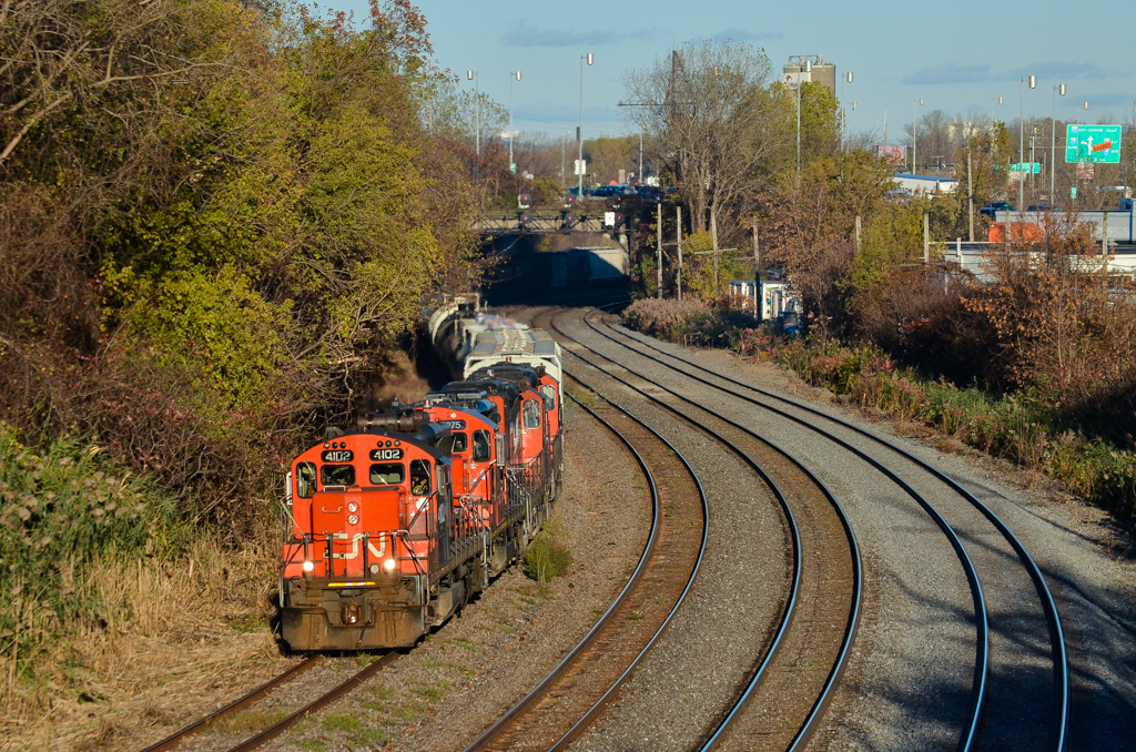 Quad GP9's. Four GP9's (CN 4102, CN 7275, CN 7017 & CN 7031) are in charge of CN 527 today, operating on the transfer track. This track has primarily been used for storage of cars the past few years, but since CN cleared the growth from this track a month ago, there has been an increase in traffic on it. For more train photos, check out http://www.flickr.com/photos/mtlwestrailfan/