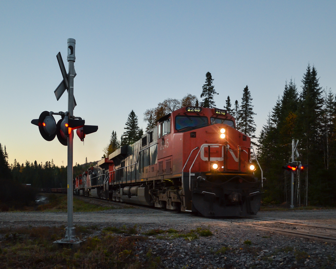 A five-unit lashup (CN 2245, CN 2232, CN 2685, CN 8873 & CN 2323, not all powered) heads north through CN's remote and scenic Lac St-Jean sub. The sun is just rising and unfortunately this will be the last place to photograph this train as it will soon enter and even more remote part of Quebec with few grade crossings. For more train photos, check out http://www.flickr.com/photos/mtlwestrailfan/