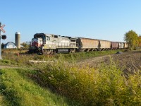 <b>Stranded.</b> The Montreal, Maine & Atlantic's short Stanbridge Subdivision is not in use, as Transport Canada is "restricting movements on the subdivision until the track has been assessed by a professional engineer and the conditions under which a safe movement may occur have been provided". The branch line is in very bad shape, with 100 lb rail, rotting ties, etc. This train, with MMA 8583 and 8 cars is therefore stranded both because of this decision and because their are 2 derailed cars about half a mile north of where this train is stranded (at MP 6.15 of the sub). Apparently this train has been there a couple of months! There are also three grain cars stranded near the end of the line in Bedford. As I was taking pictures, a farmer ploughing his field came up to ask me what all the fuss was about. He can't understand why so many people have been coming by to take photos. Just as I got here, a young couple with a 5 year old child came to take pictures of their son propped up on the engine!