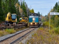 VIA's train from Jonquière in northern Quebec is about 90 minutes late as it passes some MoW equipment on the Talbot siding. The train consists of VIA 6446 followed by two stainless steel coaches and a baggage car. The power is turned at Jonquière on a turntable, but the cars are not turned, hence the baggage car at the rear end. For more train photos, check out http://www.flickr.com/photos/mtlwestrailfan/