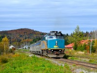 VIA's train from Jonquière in northern Quebec has just made its station stop at Rivière-à-Pierre and is heading south again. The train consists of VIA 6446 followed by two stainless steel coaches and a baggage car. The power is turned at Jonquière on a turntable, but the cars are not turned, hence the baggage car at the rear end. For more train photos, check out http://www.flickr.com/photos/mtlwestrailfan/ 