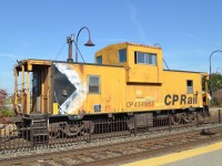 <b>Good looking caboose.</b> CP 434957 is a common sight on work trains and locals in the Montreal area and is in great shape all things considered. Here it brings up the rear of a ballast train at Dorval. For more train photos, check out http://www.flickr.com/photos/mtlwestrailfan/