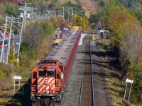 A partially loaded ballast train heads west through Pointe-Claire, with the tail end passing through the AMT Pointe-Claire station where it dumped some ballast. In the distance is Mount-Royal. Power is CP 6020 & CP 5874 and at the rear is caboose CP 434957. CP did a lot of trackwork this past weekend on the Vaudreuil Sub, causing cancellation of commuter trains on this line. For more train photos, check out http://www.flickr.com/photos/mtlwestrailfan/