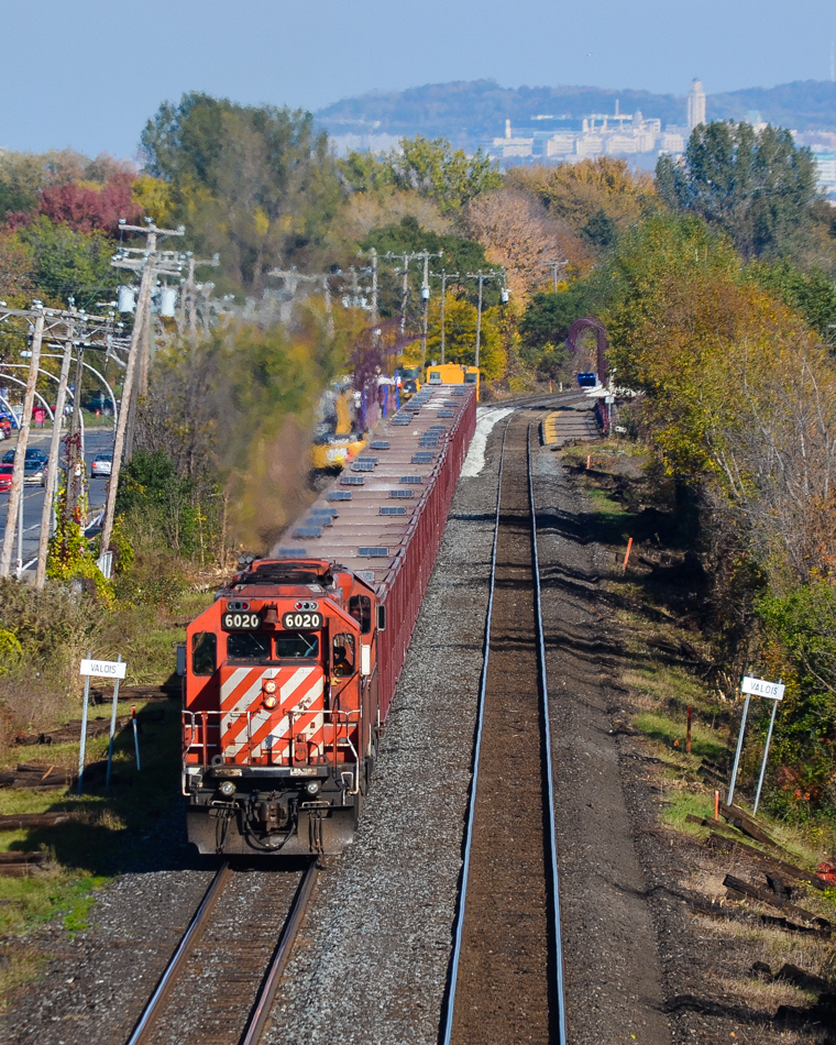 A partially loaded ballast train heads west through Pointe-Claire, with the tail end passing through the AMT Pointe-Claire station where it dumped some ballast. In the distance is Mount-Royal. Power is CP 6020 & CP 5874 and at the rear is caboose CP 434957. CP did a lot of trackwork this past weekend on the Vaudreuil Sub, causing cancellation of commuter trains on this line. For more train photos, check out http://www.flickr.com/photos/mtlwestrailfan/