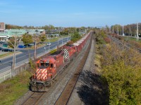 A partially loaded ballast train heads west through Pointe-Claire. Power is CP 6020 & CP 5874, both with multimarks. At the rear is caboose CP 434957. CP has been doing a lot of trackwork this past weekend on the Vaudreuil Sub, causing cancellation of commuter trains on this line. For more train photos, check out http://www.flickr.com/photos/mtlwestrailfan/ 