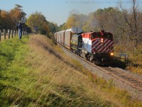 The OSR Woodstock Job  passing the Ingersoll sign on its way to Woodstock with OSRX 644 and OSRX 6508.  Fellow railfan James Adeney is seen further down the line capturing his video of the train.