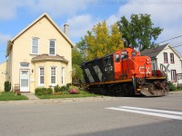 CN 4112 rumbles past the houses on Port Street in down town Brantford Ontario on a sunny Wednesday morning.