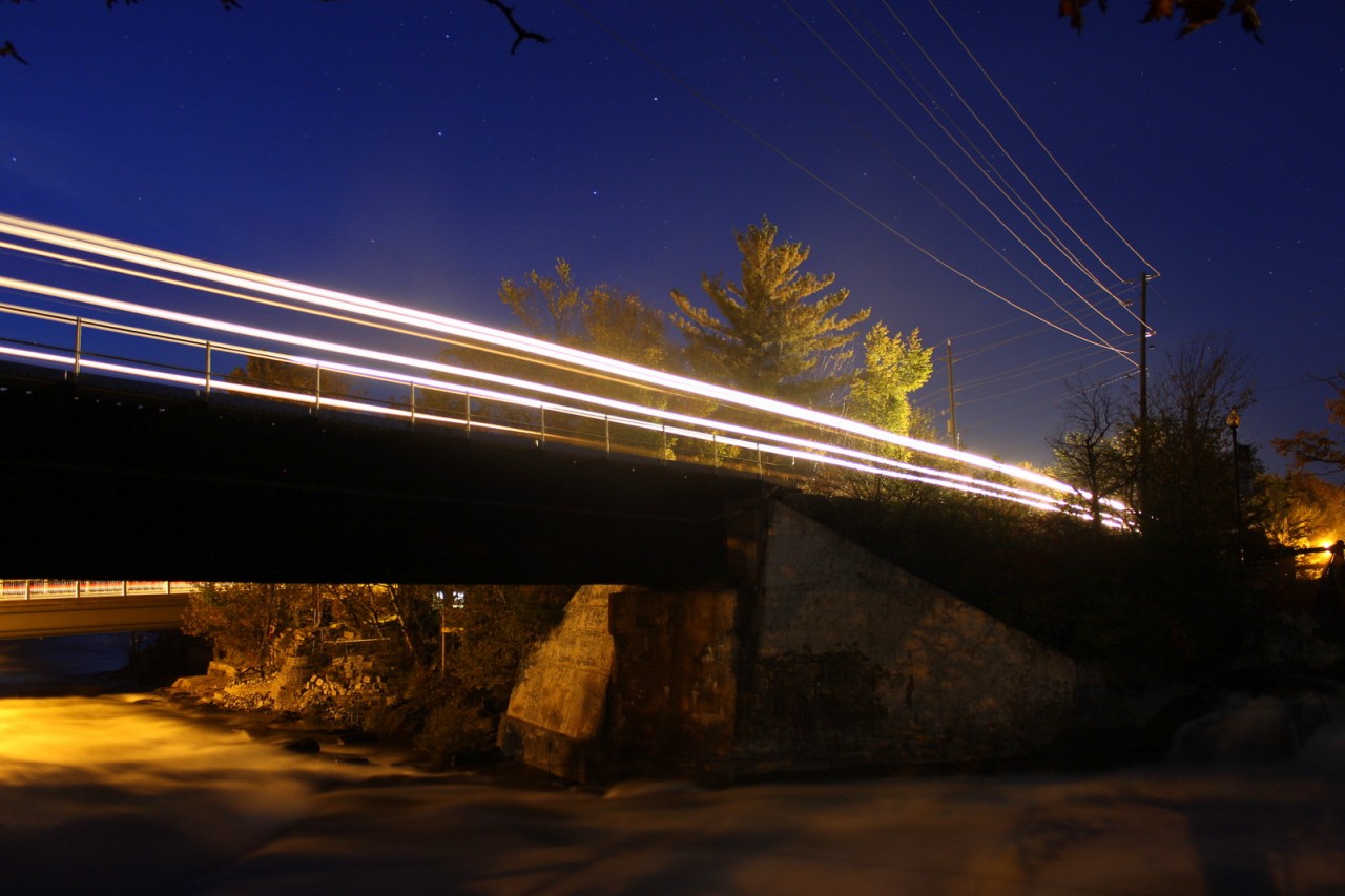 CP Mixed freight makes its way through Bala passing over the rushing water from the dam