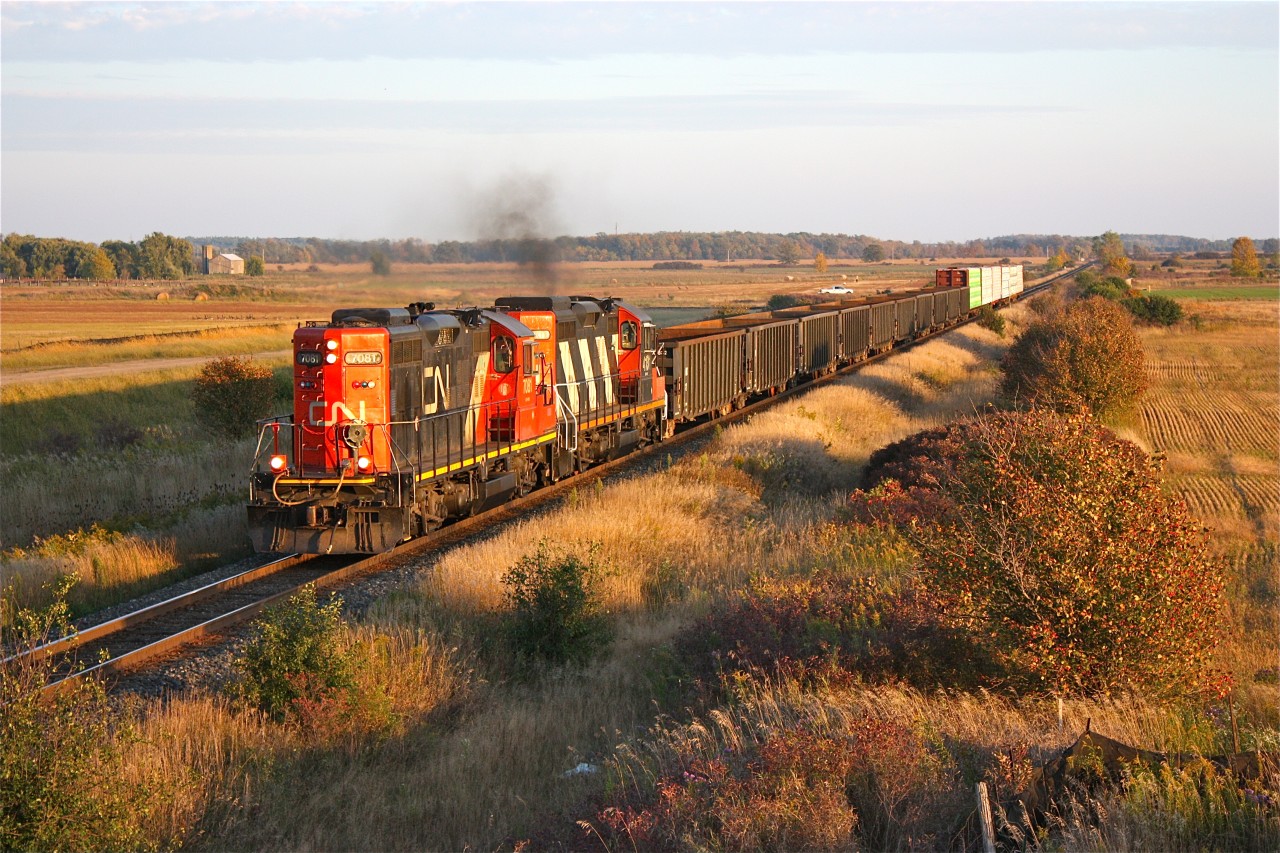 Long shadows encroach the tracks as a pair of long hood forward GP9RMs in charge of train #547 are about to duck under, the under construction Louis Saint Laurent bridge on the south side of Milton. The country landscape will soon be dug under to make way for more subdivisions, and sound barriers will most likely eliminate any good photographs in the near future.