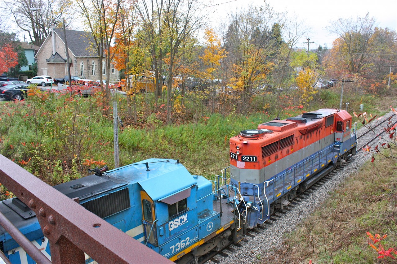 Todays #431 would be brought down to a crawl from wet rails and the steep grade up the Niagara Escarpment. GP35 #2211 with all RailAmerica markings removed was a nice change leading this day. The sound of the train barely making 2mph brought many locals out in the rain to the old bridge to witness the trains very slow passage.