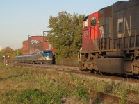 <b>St-Henri Meet.</b> A VIA westbound led by VIA 908 passes CN 5674 which is at the head end of CN 308 and awaiting a new crew.