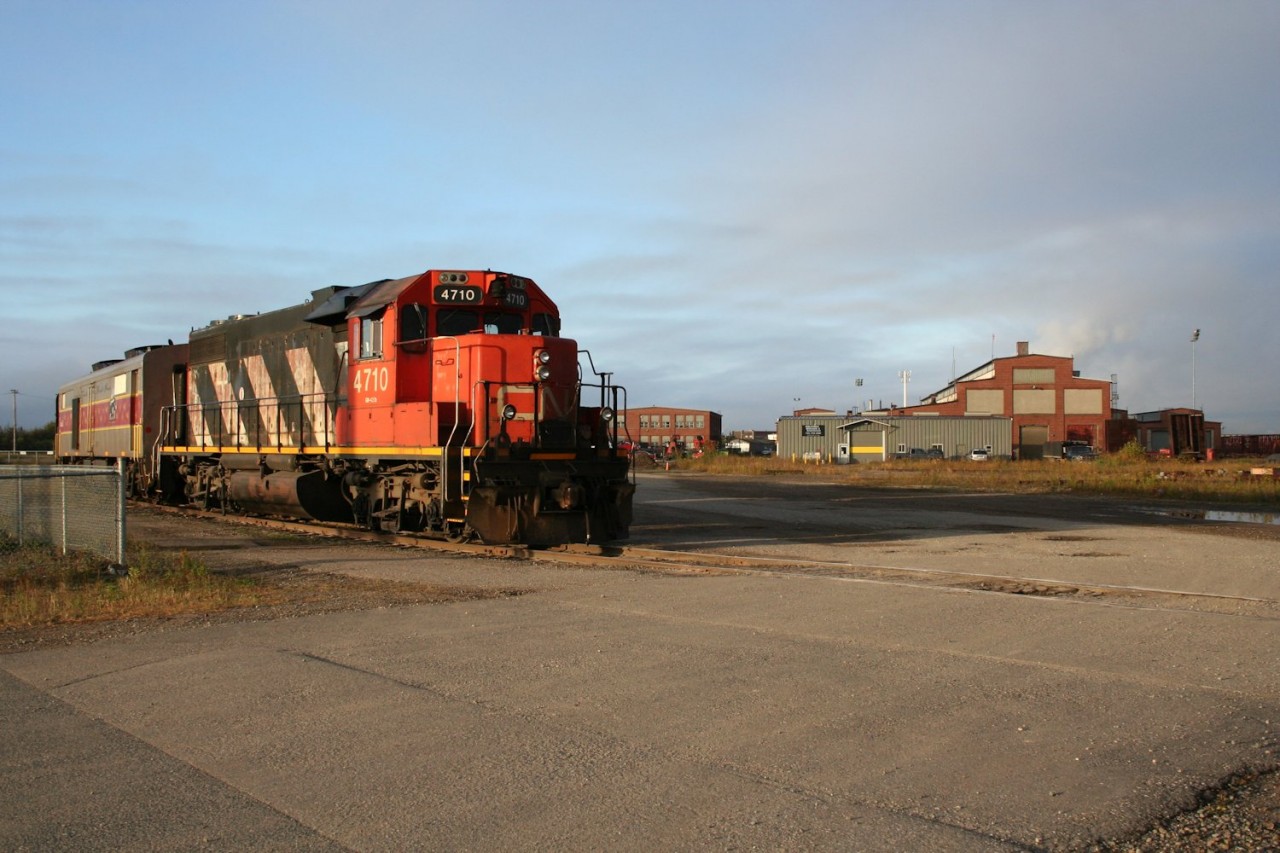 With all three F40PH locomotives assigned to a full-length Canyon Tour Train for the fall colour season, the regular passenger train to Hearst rates a standard cab CN GP38-2. In a way, this is how this train should be, even if the details are a little off. A typical 1980s consist was an AC GP38-2, steam generator car, baggage and coach. This is essentially the same, but with different colours and an electrical power generator car instead of a steam heater car.

For the last couple of years the regular train has left directly from the former ACR yard and shops area at Steelton yard instead of the passenger station downtown. A passenger loading and parking area is established near the yard entrance.