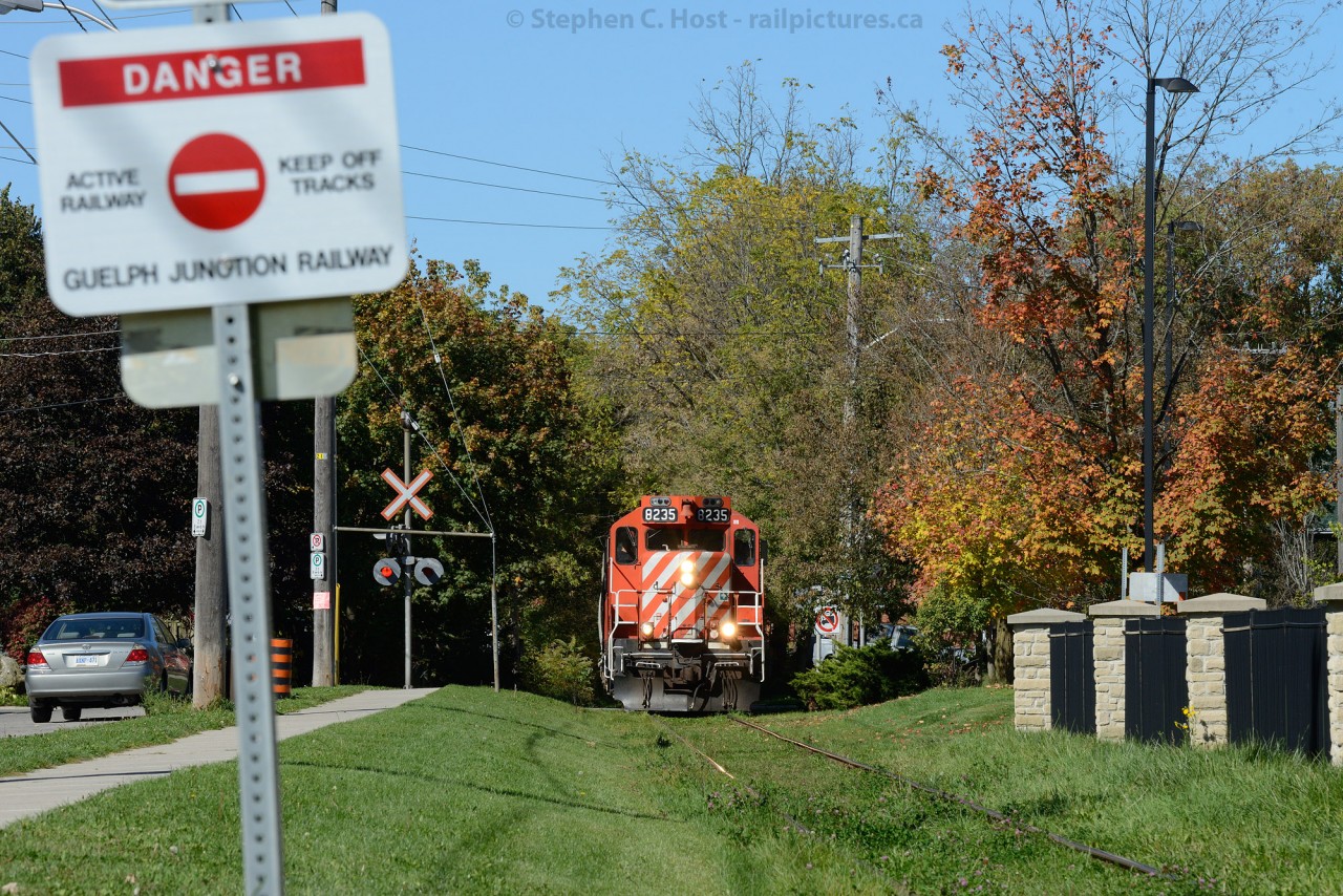 Surprise! - emerging from the 'bush' is Ontario Southland's ex CP GP9 - 8235 with SW1200 1210 and 5 cars - and a careful reminder on the sign that the Guelph Junction Railway is active - and a train can pop out of the bush at any time ;)