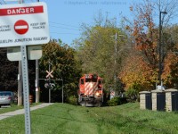 <b>Surprise!</b> - emerging from the 'bush' is Ontario Southland's ex CP GP9 - 8235 with SW1200 1210 and 5 cars - and a careful reminder on the sign that the Guelph Junction Railway is active - and a train can pop out of the bush at any time ;)

