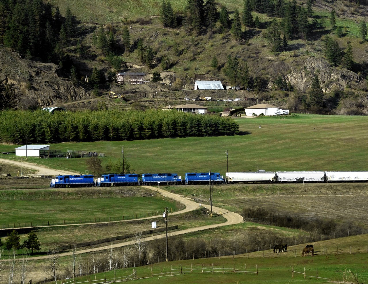 Westbound Kelowna Pacific Vernon to Kamloops tri weekly job rolls through the scenic Grandview Valley west of Armstrong on this former CN line. KP declared bankruptcy in June and CN is planning to take the line fall 2013 but wont reopen the Vernon Kelowna section.