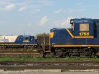Back before the CEFX GP20D invasion that brought some monotony to the fleet, early Geeps of various famed lineages called Hamilton home, some painted in an attractive blue-white-yellow livery and working out of Southern Ontario Railink (SOR)'s Stuart St. Yard. <br><br> This October evening finds GP7 1756 sitting on one of the shop tracks as GP18 1808 prepares to work an evening yard job, sorting cars for the various Hamilton industries about the yard. 1756 traces her lineage to the Detroit, Toledo & Shore Line, being built as their number 49 in April of 1952, and going on to work for Grand Trunk Western and Georgia Central as their 6049 prior to rebuilding for SOR. 1808 is a January 1960 unit that comes from the famed Chicago, Rock Island & Pacific (the "Rock Island"), where she hung out with some of the other CRIPs as their 1334. Careers on the Central Vermont and Georgia Central as 3614 then followed before C&F Locomotive chopped her nose like 1756, and sent her to SOR in the late 90's. <br><br> Fast forward to 2013: 1756, shown here with a bent frame after a yard accident, was cut up in October of 2008 with some other units. 1808 soldered on a few years later until retirement, when she was bought by dealer Sterling Rail along with 3 other SOR locos. While two of them were cut up, 1808 and fellow Geep 1755 (an ex-Conn, nee-Pennsy '9 from the class of '56) were sold to Cando Contracting in May of 2013, and currently reside in Utopia (near Barrie ON) awaiting reactivation for the next chapter in their lives. <br><br> <i><u>More SOR Geeps:</u></i><br> Keepin' it real in Stelco: <a href=http://www.railpictures.ca/?attachment_id=3109><b>http://www.railpictures.ca/?attachment_id=3109</b></a><br> A Saturday gang meet: <a href=http://www.railpictures.ca/?attachment_id=2053><b>http://www.railpictures.ca/?attachment_id=2053</b></a><br> Crusin' around town:  <a href=http://www.railpictures.ca/?attachment_id=1217><b>http://www.railpictures.ca/?attachment_id=1217</b></a><br> Dashing through the snow, second fiddle: <a href=http://www.railpictures.ca/?attachment_id=284><b>http://www.railpictures.ca/?attachment_id=284</b></a>