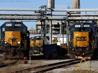 <b> A maze of pipelines </b> confuse the viewer at the CSXT's Clifford St. Depot in Sarnia. Most of the clutter seen here is from the Imperial Oil plant - which grew around the Railway, literally. This facility is just one of a few reasons why CSXT continues to operate what I dub "the Class 1 Shortline".<br><br>Railway details in this scene - 2757 is parked on the "old main" and was involved in a Sideswipe a few weeks ago. Some damage is on the rear of the unit (not shown). 2574, paired with remote 2561 is parked behind the permanently installed "CROR 26.1" Blue Signal protection, which is in effect when the gyrolight  is activated. This signal is used when the Mechanic is on duty, usually overnight. The yellow tripod-structure is used to hold two FRED's for jobs that venture out of town - but with the line recently changed (October 4 2013) to Rule 105, these may no longer be required.<br><br>The other three units in the background are parked at the "three stall" "roundhouse" - 2672, 2570, 2690 (not shown). The structure was built by the Erie and Huron as a six or so stall roundhouse between 1900 and 1910 and reduced in size sometime thereafter. Today, only a single stall can be used of the three doors and the building is clad, on two sides, in aluminum siding.<br><br>Photo taken from public property using a long lens. Not advised to go anywhere but here due to on-site security.