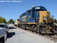 <b>Last train</b> to Wallaceburg has arrived at the Bridgetender/RTC's office and has to grab some paperwork. All the trucks on the driveway are for the people who have come to see the train off, all of them CSX Employees.<br><br>With Caboose 900074 in tow. Today's work - 12 loaded grain cars from Southwest AG (Formerly Hazzards) on the south side of the Syndeham River, and to close the bridge for the last time. This is the last CSX Train to Wallaceburg, as on October 4 2013 the Region of Chatham-Kent becomes the new owners of all you see here and to Chatham. <br><br>Chatham-Kent is still seeking an operator for the line as there are four customers at the present time - Southwest AG Partners (Hazzards) in Wallaceburg, IGP also in Wallaceburg (On the north side, former Libbys glass lead), A large grain elevator owned by LAC (London Agricultural Products) at Tupperville, and a fertilizer facility (also South West AG Partners) at Eberts. A large food processing facility (ConAgra foods) at Dresden is also a potential customer and a spur still exists to the plant, which was formerly part of the Dresden Belt Line.