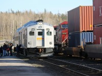 VIA 185 has arrived at White River, Ontario and is holding the mainline to detrain the passengers in front of the old station building. On the adjacent passing track an eastbound intermodal creeps by. Once the passengers and the eastbound are all clear, the VIA crew will park the rail diesel cars in the yard until the return trip tomorrow morning.