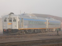 Early morning in White River, Ontario. The fog is slowly melting as the rays of the rising sun shine through revealing the pair of VIA diesel rails cars that overnighted in the yard. The crew will be boarding soon to prepare for the return trip to Sudbury.