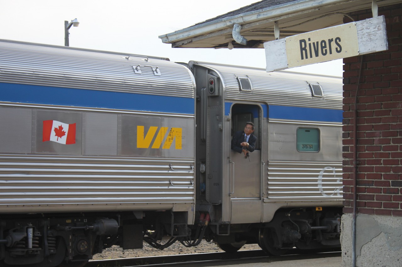 A VIA Rail crew member waits for the train to make its second stop on the platform in Rivers to load and unload the next set of passengers on this Train 2.
