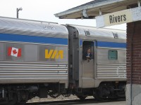 A VIA Rail crew member waits for the train to make its second stop on the platform in Rivers to load and unload the next set of passengers on this Train 2.