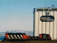 The morning yard turn out of Thunder Bay North has arrived at the Agricore A grain elevator situated on the north side of the Thunder Bay waterfront.  In the background above yard power cn4808, cn265, cn7224 there is ice in the bay and snow on The Sleeping Giant. The railways are busy switching loads in and empties out at the elevators as the lake boats arrive at the elevators for the spring grain rush.