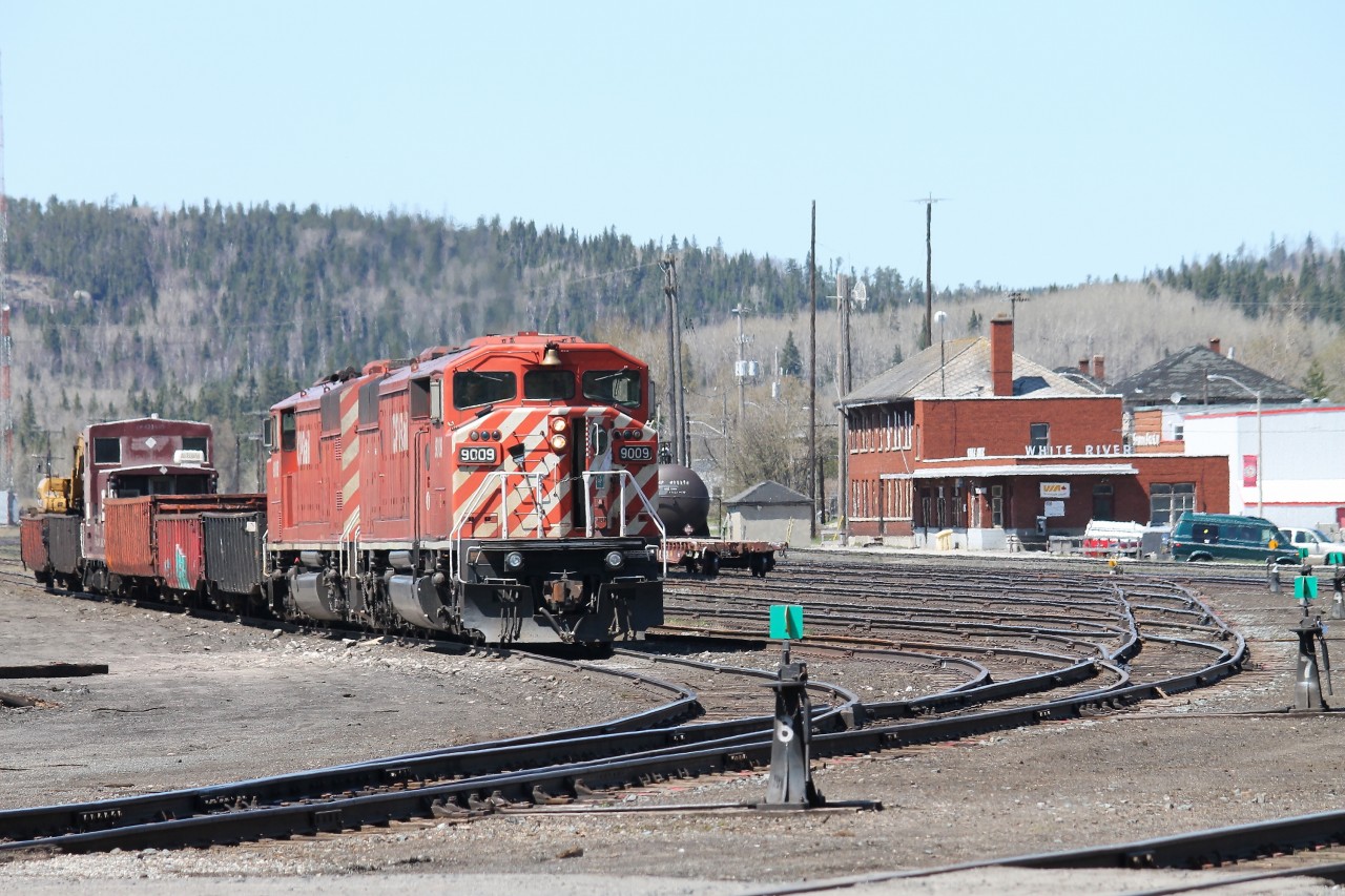 The crew on the CP work train have called it ‘a day’ and have returned with the train to the yard at White River. The crew had spent the day picking up old ties along the right-of-way to the west of White River on the Heron Bay subdivision. It is rare to see a pair of red barns, as in this instance with SD40-2F’s 9009 and 9008 paired together.