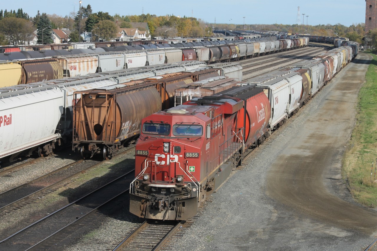 The CP Westfort yard is almost full with loaded and empty grain hoppers during the fall grain rush from the prairies to the elevators in Thunder Bay. Single unit CP 8855 has backed onto a string of 112 empties on track AC40 and will soon be departing westward.