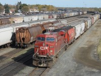 The CP Westfort yard is almost full with loaded and empty grain hoppers during the fall grain rush from the prairies to the elevators in Thunder Bay. Single unit CP 8855 has backed onto a string of 112 empties on track AC40 and will soon be departing westward. 