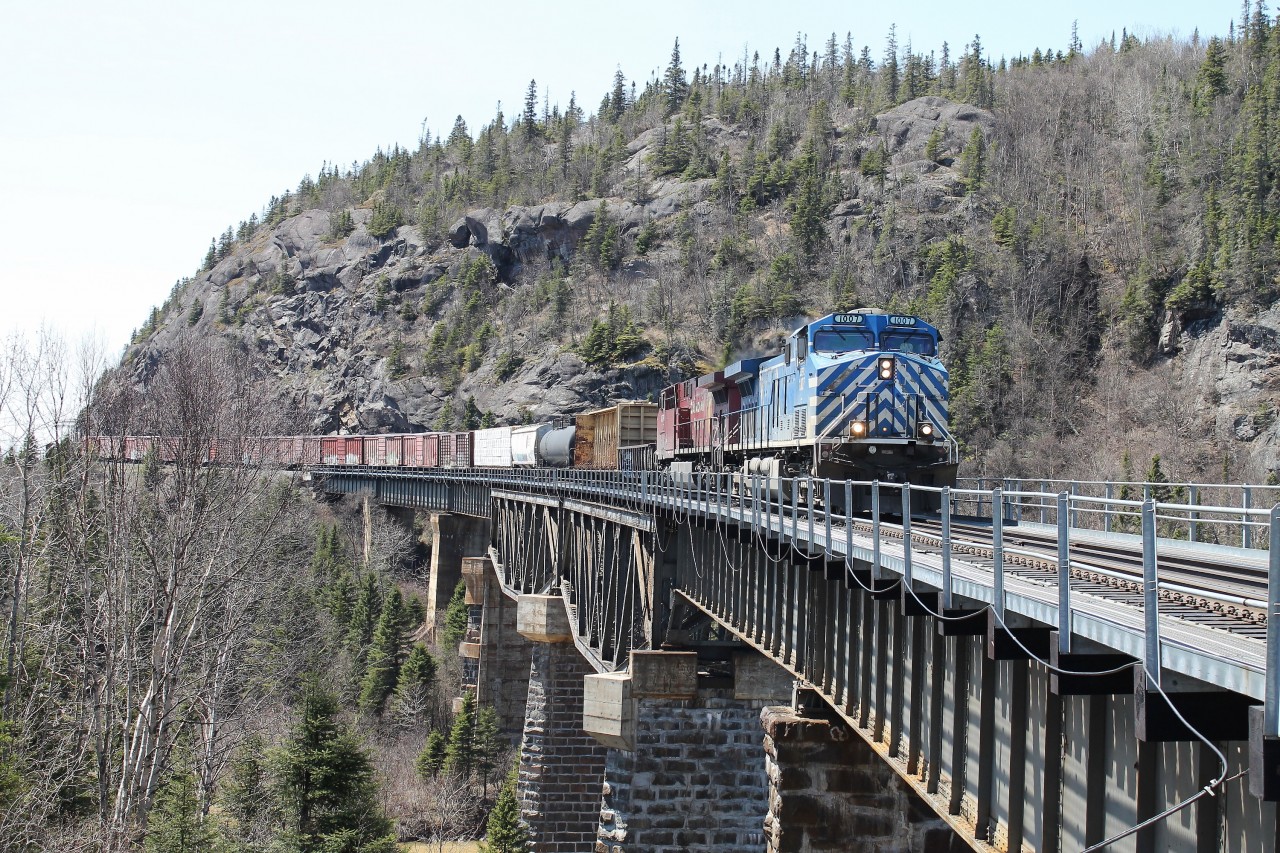 CP train 420, with CEFX1007 leading and cp8570 trailing, is almost across the final span over the Little Pic River. Coming east from Middleton the roadbed is blasted out from the side of the rock cliff, then seven spans on a curve are needed to bridge the river; and once across, the road bed continues to curve and almost completes a horseshoe.