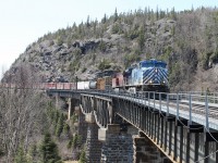 CP train 420, with CEFX1007 leading and cp8570 trailing, is almost across the final span over the Little Pic River. Coming east from Middleton the roadbed is blasted out from the side of the rock cliff, then seven spans on a curve are needed to bridge the river; and once across, the road bed continues to curve and almost completes a horseshoe.