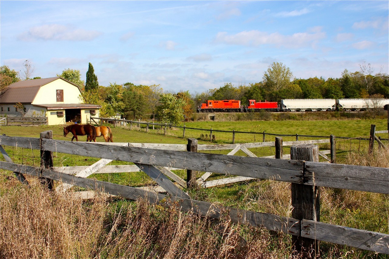 OSRs former CP GP9 and SW1200 pass the barn and horses at Arkel
