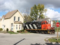 Train 580 rattles the houses as it tons along the old TH&B B Waterford  subdivision Heading to the last surviving customer on the spur.