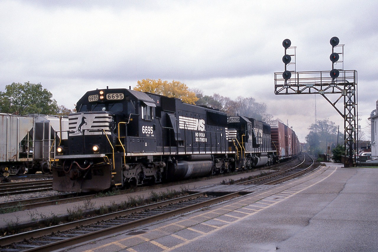 On a gray October day, a late NS 327 passes through Brantford with a long train of auto parts boxcars for St. Thomas.