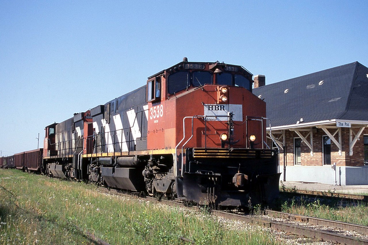 After waiting for a switch job to head out to the Tolko mill north of town, HBRY train 991 to Flin Flon pulls out of the yard and passed the station in The Pas.