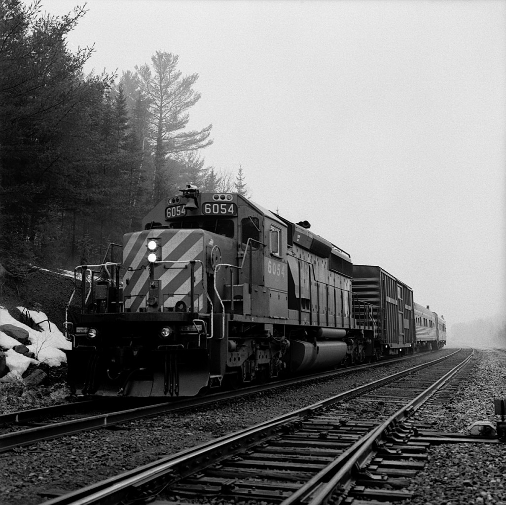 TEC train holds the main for a CP stacker at the east switch Levack.  Dynamic brake was cut out, and the automatic brake locked the wheels anything beyond a minimum service on the evaluating car, which the folks back there didn't want.  Needles to say, my hogger was not in a good mood.  Later on that trip we encountered a small washout in the siding at Stinson.  Nothing serious, but there was a big hole undermined underneath about 4 or 5 ties.