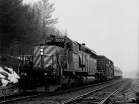 TEC train holds the main for a CP stacker at the east switch Levack.  Dynamic brake was cut out, and the automatic brake locked the wheels anything beyond a minimum service on the evaluating car, which the folks back there didn't want.  Needles to say, my hogger was not in a good mood.  Later on that trip we encountered a small washout in the siding at Stinson.  Nothing serious, but there was a big hole undermined underneath about 4 or 5 ties.