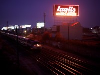 An eastbound GO pounds the plant at Fort York under the pink glow of the (original) Inglis sign.  This scene has changed quite a bit.