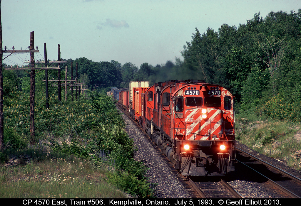 CP M630 #4570 has 2 sister Alcos and train #506 well in hand as it rolls through eastern Ontario just east of Kemptville on July 5, 1993.