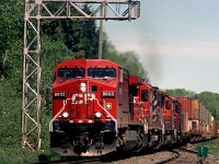 CP 8603 has train #119 in hand as it passes under the cantilever signal that governs eastbound movements on the trans-continental main at the East Siding Switch Loon, in Loon, Ontario back in 2004.