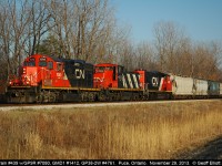 In what can be described as an "only on CN" lashup we have CN GP9r #7040, GMD1 #1412, and GP38-2W #4761 leading a short CN #439 train through Puce, Ontario on November 29, 2013.  Talk about a 'classic' CN lashup!!