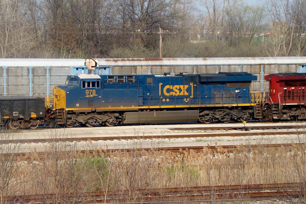 CSX D718 is seen here switching CN's Electric Yard after dropping off interchange cars for CN and The Essex Terminal Railway. This shot is taken from a berm that follows alongside the yard. The former CASO main is seen in the bushes near the bottom of the photo.