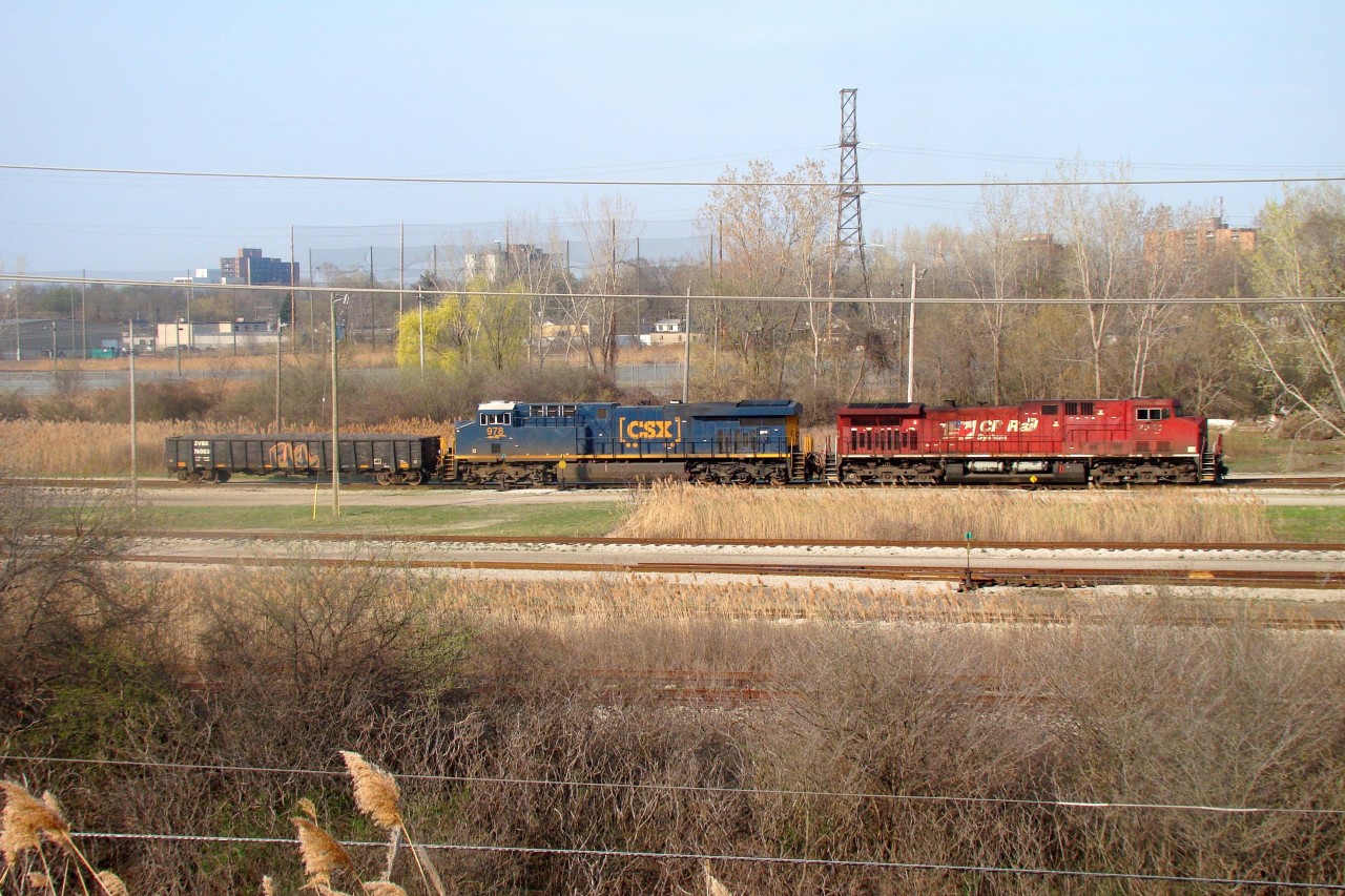 CSX D718 is seen here switching CN's Electric Yard after dropping off interchange cars for CN and The Essex Terminal Railway. This shot is taken from a berm that follows alongside the yard. The former CASO main is seen in the bushes near the bottom of the photo.